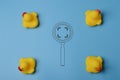 Magnifying glass and toy ducks. Hiring and job vacancy concept