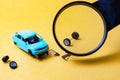 With a magnifying glass view of the broken car on a yellow background Royalty Free Stock Photo