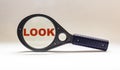 Magnifying glass, on a white background with the word LOOK Royalty Free Stock Photo