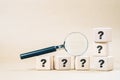 Magnifying glass with many question marks Royalty Free Stock Photo