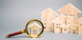 Magnifying glass and wooden houses. House searching concept. Home appraisal. Property valuation. Choice of location for the Royalty Free Stock Photo