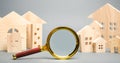 Magnifying glass and wooden houses. House searching concept. Home appraisal. Property valuation. Choice of location for the Royalty Free Stock Photo