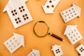 Magnifying glass and wooden houses. House searching concept. Home appraisal. Property valuation. Choice of location for the Royalty Free Stock Photo