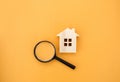 Magnifying glass and wooden houses. House searching concept. Home appraisal. Property valuation. Choice of location for the Royalty Free Stock Photo