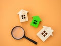 Magnifying glass and wooden houses. House searching concept. Home appraisal. Property valuation. Choice of location for the Royalty Free Stock Photo