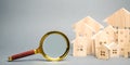 Magnifying glass and wooden houses. House searching concept. Home appraisal. Property valuation. Choice of location for the Royalty Free Stock Photo
