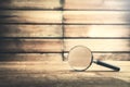 Magnifying glass on wooden table. Search and discover Royalty Free Stock Photo