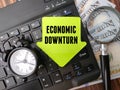 magnifying glass with the word ECONOMIC DOWNTURN. Royalty Free Stock Photo