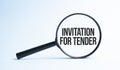 Magnifying glass with the word INVITATION FOR TENDER. Business concept