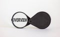 Magnifying glass with word overview on beautiful white background. Business concept, copy space