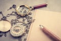 Magnifying Glass wuth pencil and blank notebook on grey leather Royalty Free Stock Photo