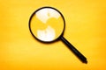 Magnifying glass on yellow background