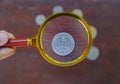 Magnifying glass zoom coin collect on the wood table Royalty Free Stock Photo