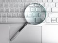 Magnifying lens over laptops keyboard. Seo and search concept Royalty Free Stock Photo