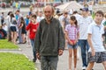 Magnitogorsk, Russia, - August, 22, 2014. An elderly homeless man walks in a crowd around a city square. Social contrasts