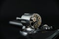 357 magnum caliber revolver pistol, cylinder open with bullets protruding from the gun