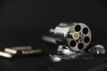 357 magnum caliber revolver pistol, cylinder open with a single bullet protruding from the gun