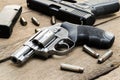 .357 magnum revolver, 9mm pistol, bullets and, magazines on wooden table. Royalty Free Stock Photo