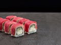 Maguro Tuna sushi roll with cucumber and cream cheese inside roll on dark concrete background Royalty Free Stock Photo