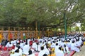 Large group of pilgrims seated alongside the Bodhi Palanka, the Place of Enlightenment located under the Bodhi Tree