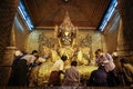 Bhuddist communing with Bhudda in the Mahamuni Buddha Temple, Mandalay Region, Mandalay, Myanmar