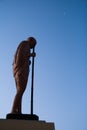 Mahatma Gandhi Statue with blue sky and crescent moon Royalty Free Stock Photo