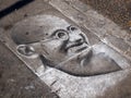 London, England - September 29 2015 : Mahatma Ghandi chalk drawing on the pavement floor at Camden Market London