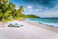 Mahe, Seychelles. Sun lounger at beautiful Anse intendance, tropical beach. Blue ocean waves, sandy beach and coconut