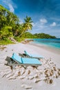 Mahe, Seychelles. Two sun lounger at beautiful Anse intendance beach. Blue ocean, white sand and coconut palm trees