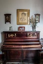 Mahogany colored piano by Federico Garcia Lorca with a portrait of the writer in the Valderrubio house
