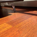 Mahogany flooring parquets in the room with armchairs in a standard home environment