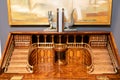 Mahogany furniture with designer hand-carved wood in the shape of the foyer and balcony.Against a gray wall and a picture.