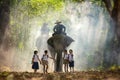 Mahout and student little asian in uniform are raising elephants on walkway in forest. Student little asian girl and boy singsong Royalty Free Stock Photo