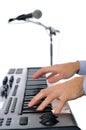 Maicrophone and male hands playing the piano