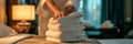 maid arranging neatly folded towels in a hotel room. Generative AI