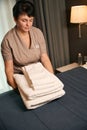 Maid is changing bathroom supplies in hotel room
