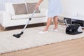 Maid cleaning carpet with vacuum cleaner Royalty Free Stock Photo