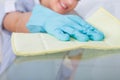 Maid cleaning glass table Royalty Free Stock Photo