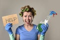 Maid cleaning woman or lazy housewife in stress in rollers with spray bottle asking for help