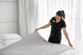 Maid making bed in hotel room. Housekeeper Making Bed Royalty Free Stock Photo