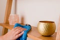 Maid dusting surface. Housekeeper doing chores and cleaning shelf Royalty Free Stock Photo