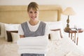 Maid holding towels in hotel room smiling Royalty Free Stock Photo