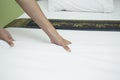 Maid making bed in hotel room Royalty Free Stock Photo