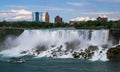 Maid of the mist cruise tour boat passing American Falls in the waters of Niagara Falls Royalty Free Stock Photo