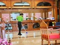 Maid mopping hotel foyer, Cleaning cosy interior in hotel lobby staff cleaning