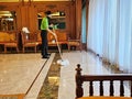 Maid mopping hotel foyer, Cleaning cosy interior in hotel lobby staff cleaning