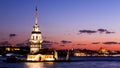Maiden Tower or Kiz Kulesi with floating tourist boats on Bosphorus in Istanbul at night Royalty Free Stock Photo