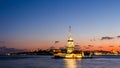 Maiden Tower or Kiz Kulesi with floating tourist boats on Bosphorus in Istanbul at night Royalty Free Stock Photo