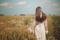 Maiden walking in a summer wheat field Royalty Free Stock Photo