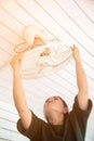 The maidservant is installing and cleaning the ceiling fan. Royalty Free Stock Photo